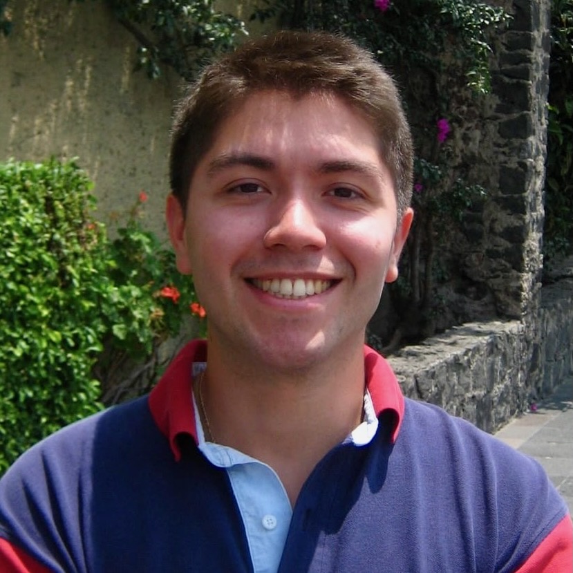 Portrait of a young man, smiling at the camera.