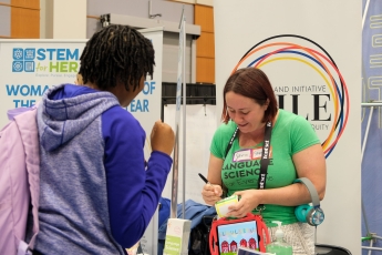 Shevaun Lewis writes a name tag for a visitor using the International Phonetic Alphabet